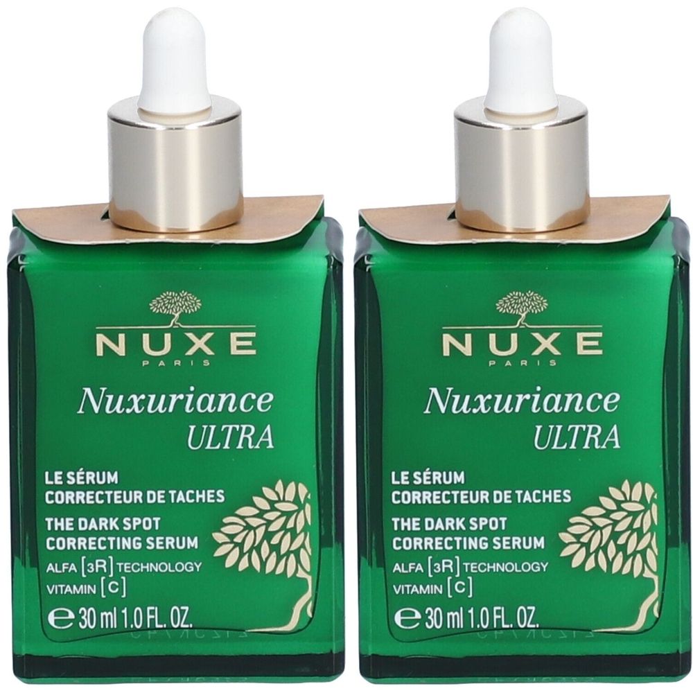Twee groene glazen flacons met gouden doppen en pipetten. Opschrift: Nuxe Nuxuriance Ultra, Sérum Correcteur de Taches.