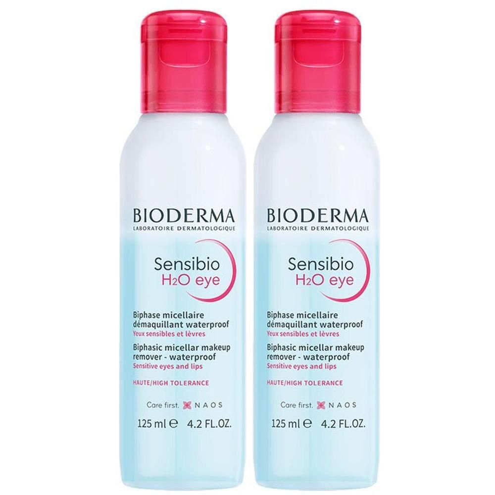Deux flacons de Bioderma Sensibio H2O eye. Flacons blancs avec bouchons roses. Inscription Sensibio H2O eye et Biphase micellaire démaquillant waterproof.