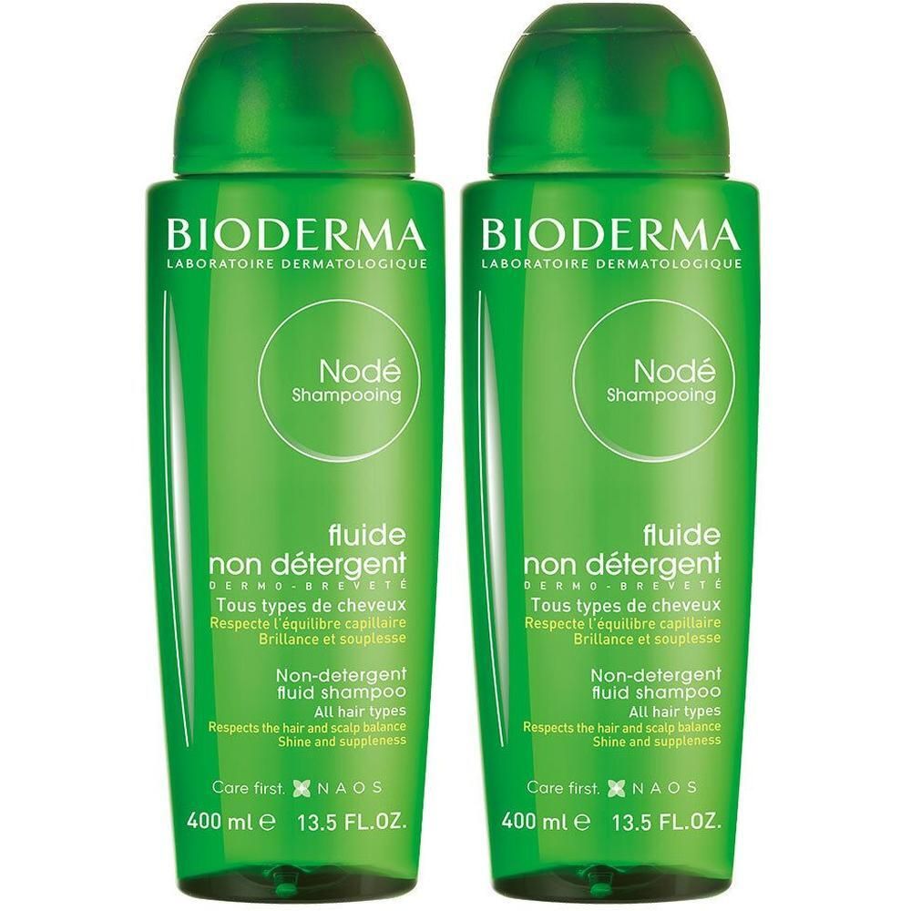 Deux flacons verts de shampooing Bioderma Nodé. Inscription: Fluide non détergent, 400 ml, 13.5 FL.OZ.