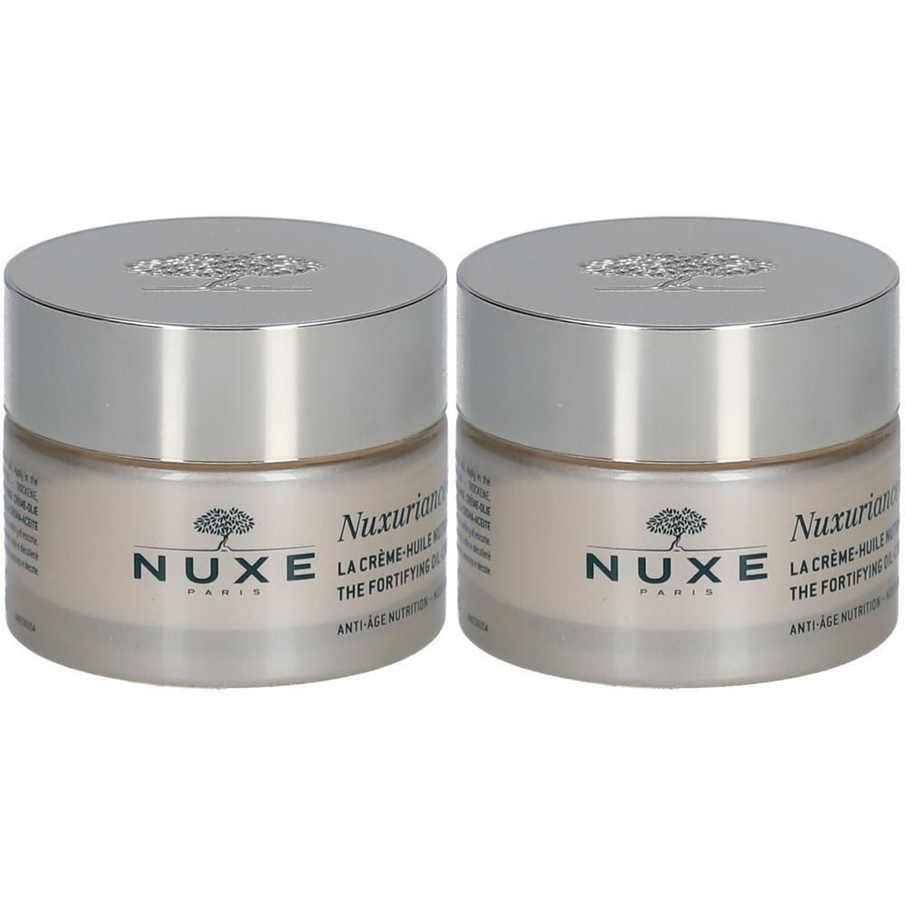 Twee potten Nuxuriance® Gold oliecrème. Glazen potten met zilveren deksels. Opschrift: Nuxe Paris.