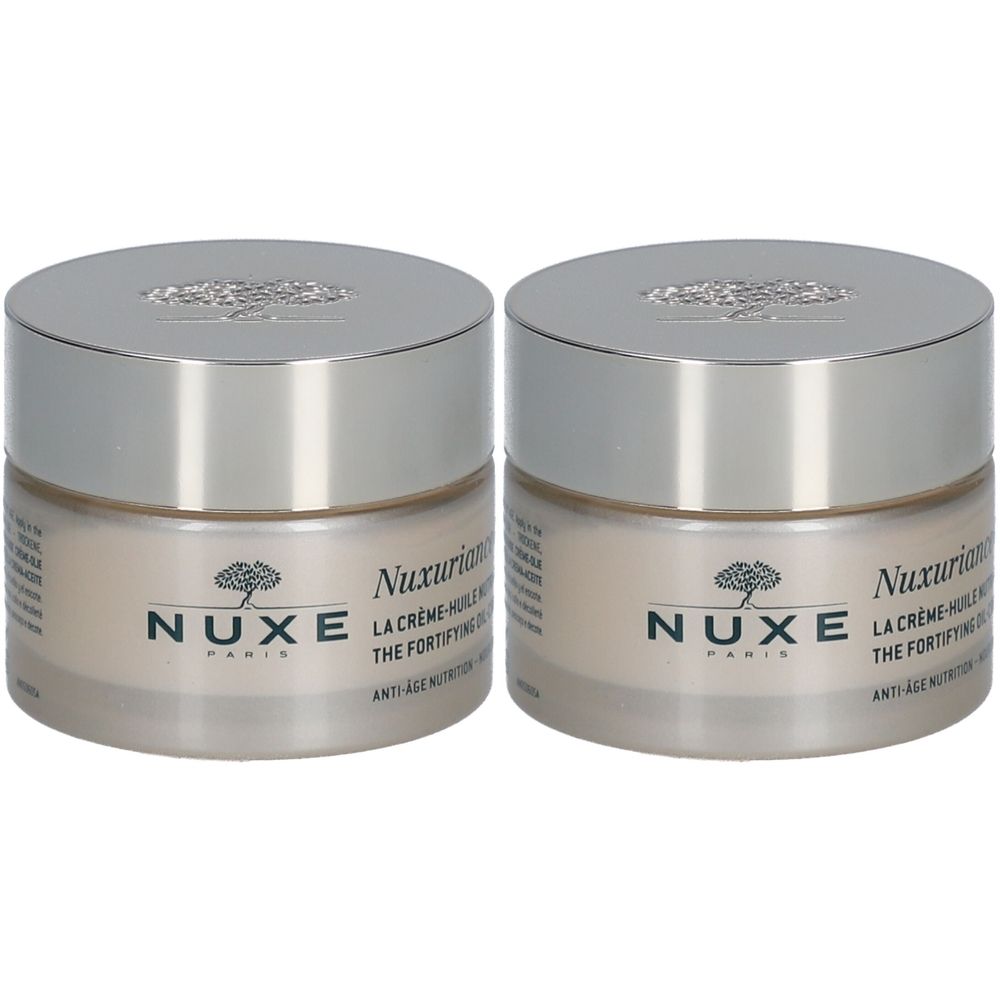 Twee potten Nuxuriance® Gold oliecrème. Glazen potten met zilveren deksels. Opschrift: Nuxe Paris.