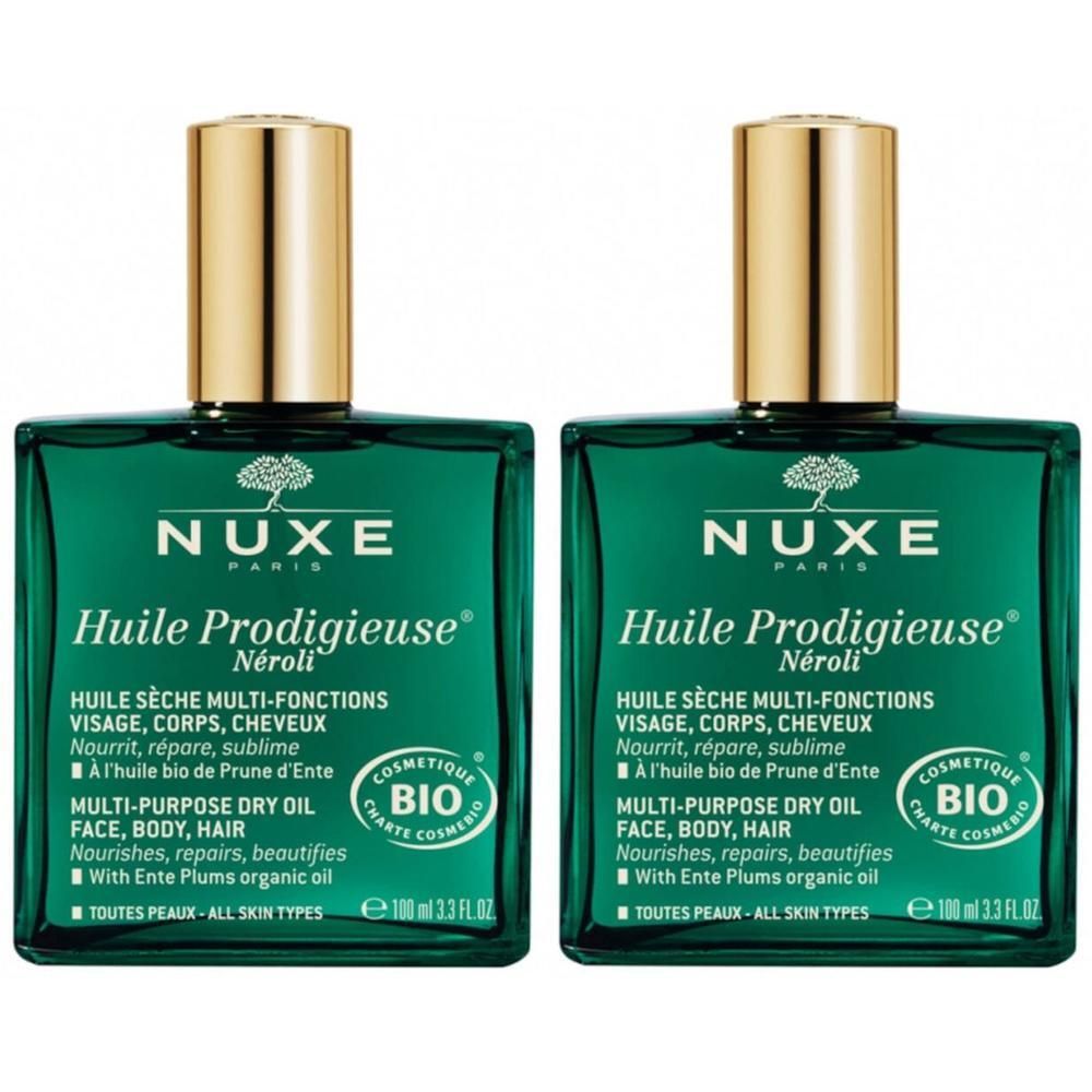Twee groene glazen flacons met gouden doppen. Opschrift: Nuxe Huile Prodigieuse Néroli Bio. Multifunctionele droge olie voor gezicht, lichaam, haar.