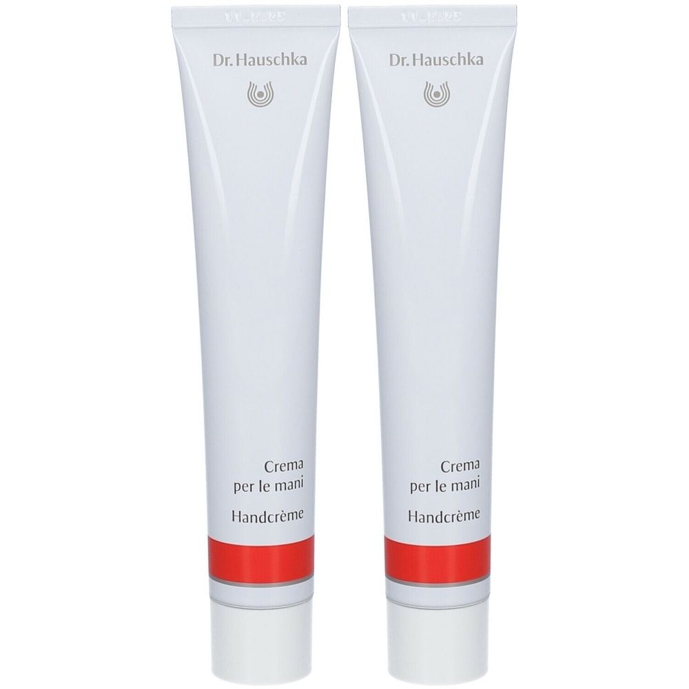 Twee witte tubes met rode streep. Opschrift: Dr. Hauschka, Crème pour les Mains, Handcrème.