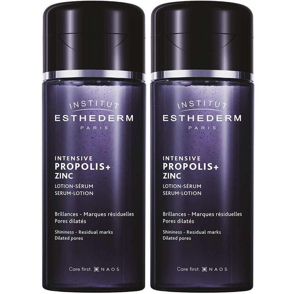 Twee flessen INSTITUT ESTHEDERM lotion-serum. Donkerviolette flessen met zwarte dop. Productnaam en tekst duidelijk zichtbaar.