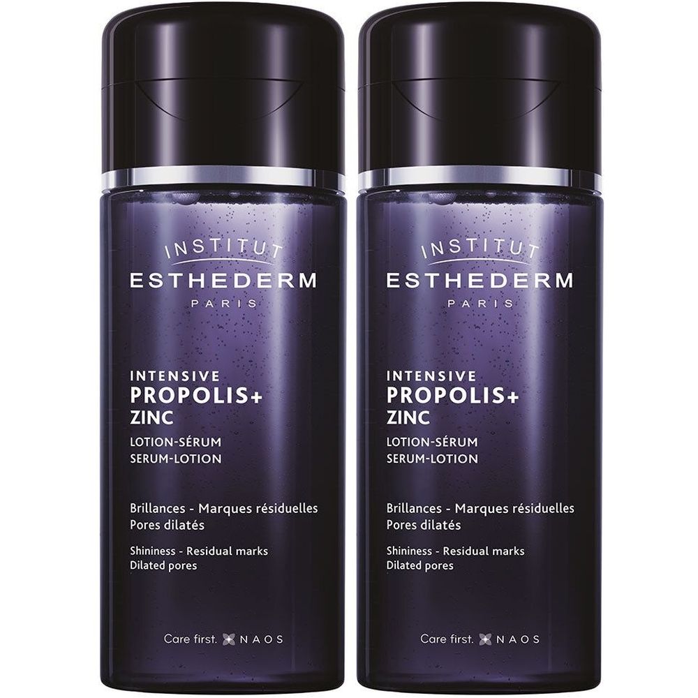 Twee flessen INSTITUT ESTHEDERM lotion-serum. Donkerviolette flessen met zwarte dop. Productnaam en tekst duidelijk zichtbaar.