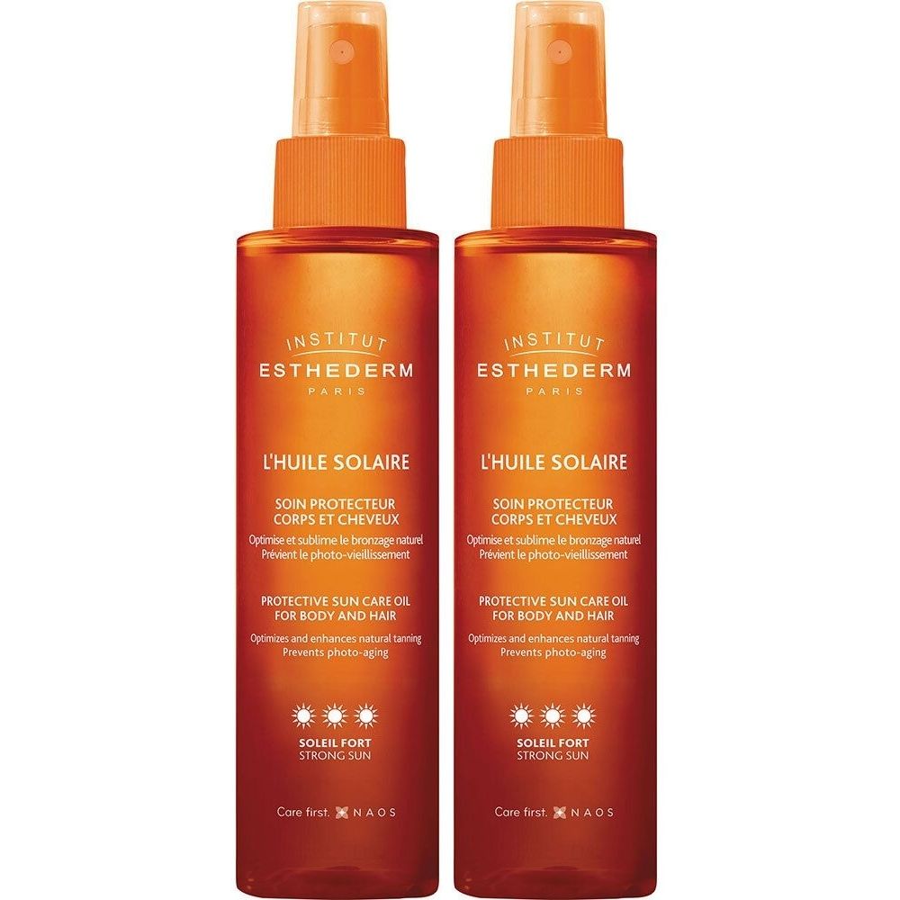 Twee sprayflacons zonneolie. Opschrift: INSTITUT ESTHEDERM, L'HUILE SOLAIRE, SOLEIL FORT. Voor lichaam en haar.