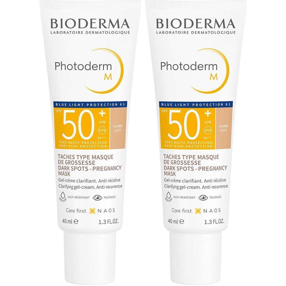 Deux tubes de Bioderma Photoderm M Gel-Crème Clarifiant Clair SPF50+. Tubes blancs avec impression jaune. Texte: Photoderm M, SPF 50.