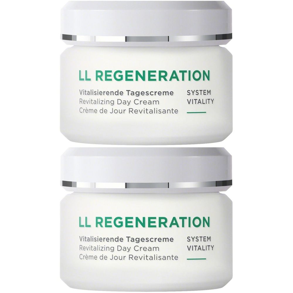 Twee witte potten met zilveren deksels. Opschrift: LL REGENERATION, Vitalisierende Tagescreme, Revitalizing Day Cream, Crème de Jour Revitalisante.