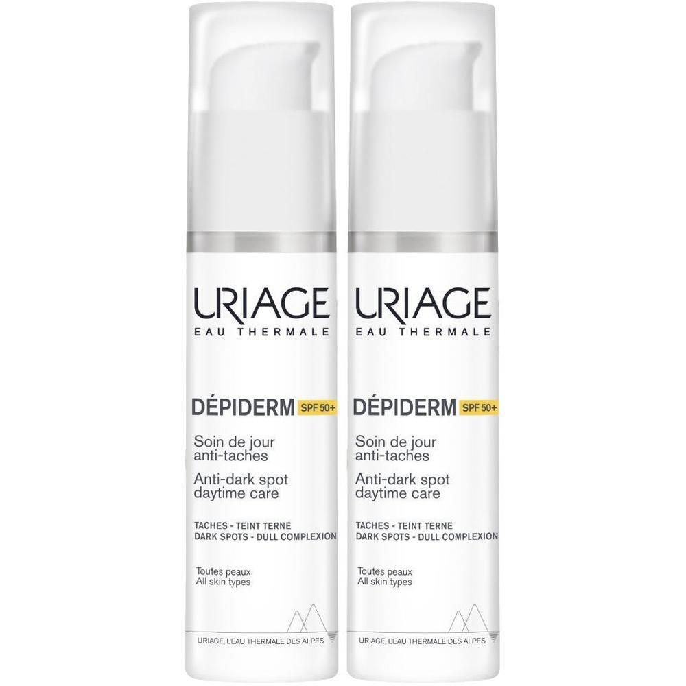 Deux flacons blancs Uriage Dépiderm SPF50+. Inscription: Anti-taches, Anti-taches sombres.