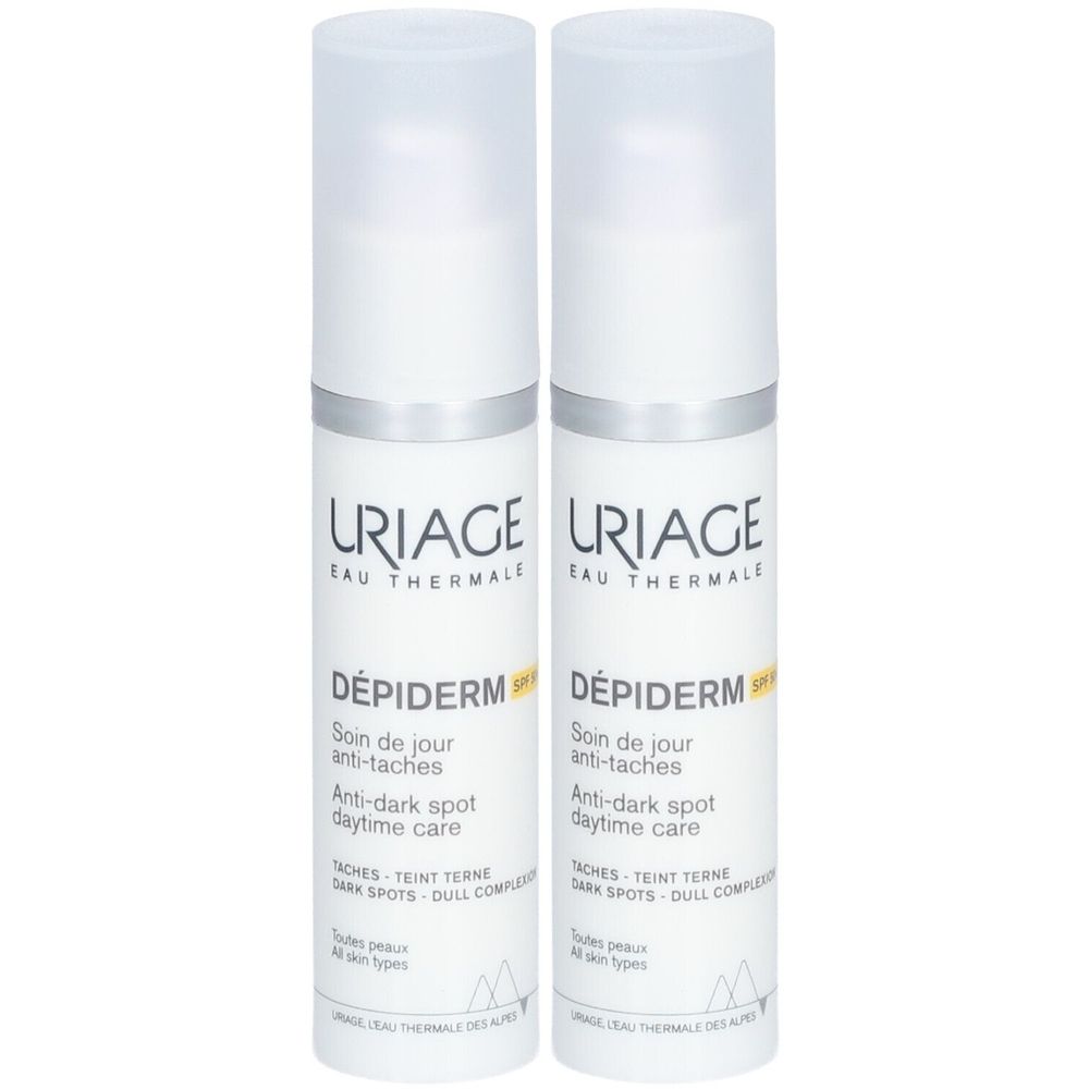 Twee witte flessen Uriage Dépiderm SPF50+ crème. Opschrift: Anti-vlekken, Anti-donkere vlekken.