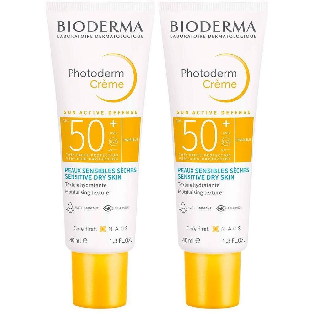 Twee tubes Bioderma Photoderm Crème. Wit, gele dop. Tekst en logo op de voorkant.