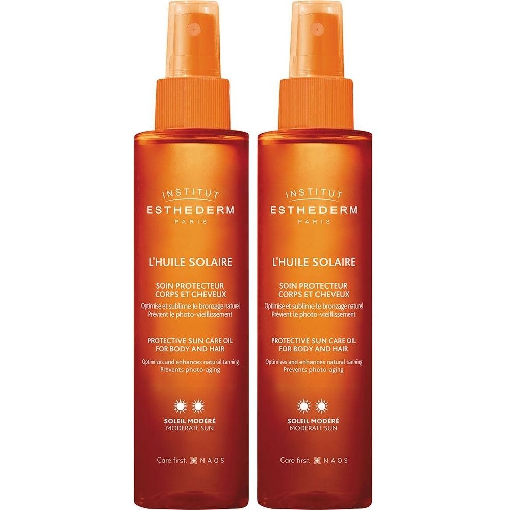 Deux flacons d'huile solaire. Têtes de pulvérisation orange, bouteilles marron avec texte blanc. Institut Esthederm.