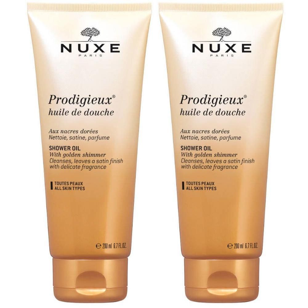 Twee tubes NUXE Prodigieux® doucheolie. Beige-gouden kleur, tekst en productnaam. 200 ml.
