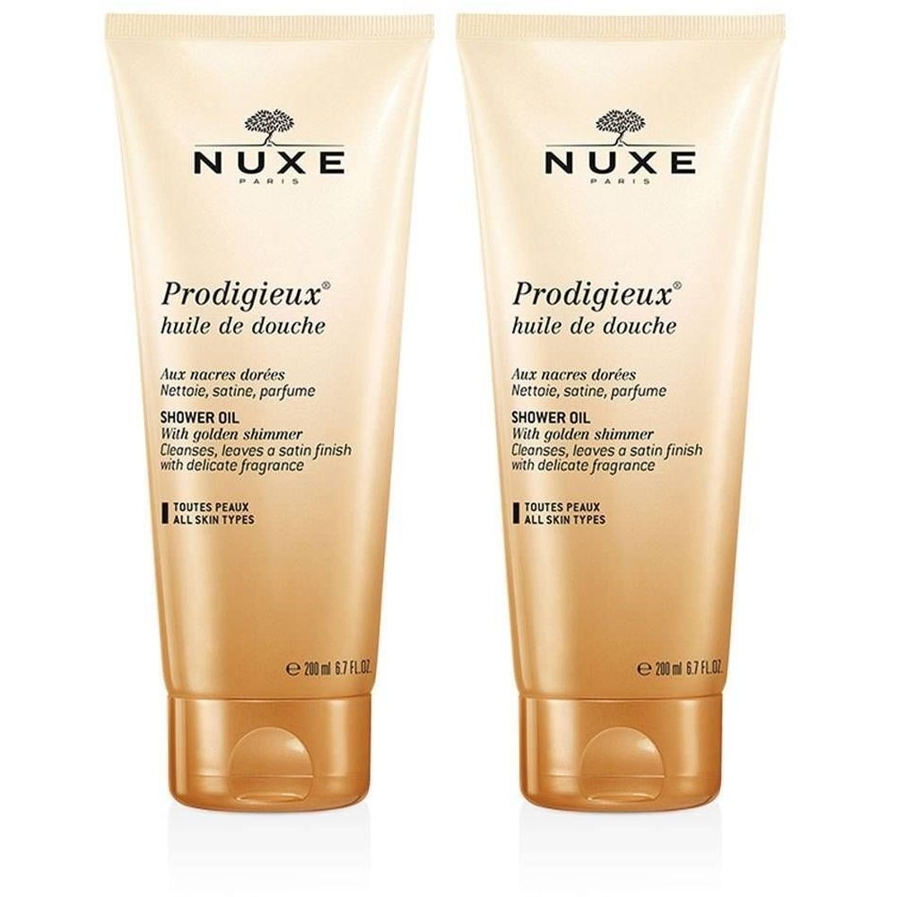 Twee tubes NUXE Prodigieux® doucheolie. Beige-gouden kleur, tekst en productnaam. 200 ml.