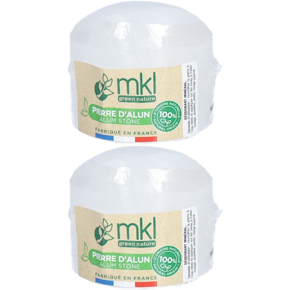 Twee ronde, transparante stenen, verpakt. Labels met "mkl green nature", "Pierre d'alun", "100% naturel".