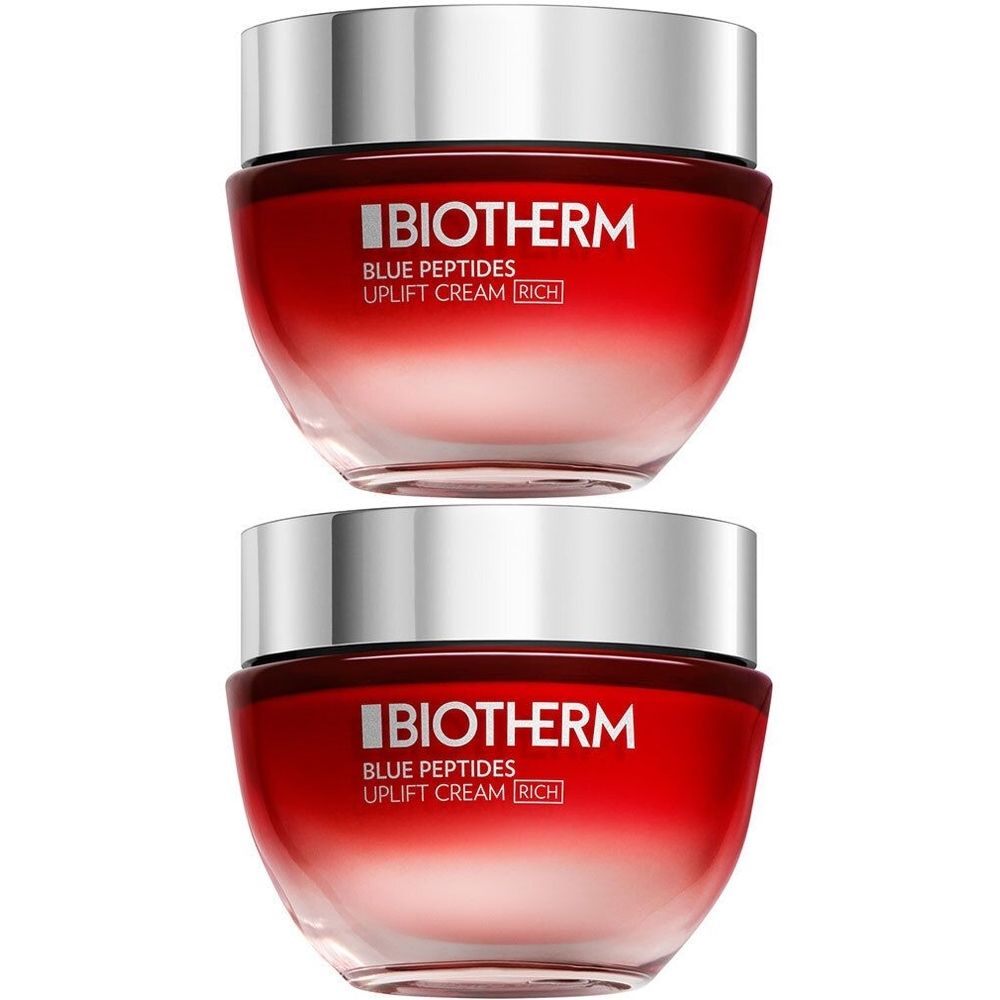 Twee potten Biotherm Blue Peptides Uplift Cream. Rode kleurovergang, zilveren deksel. Opschrift Biotherm.