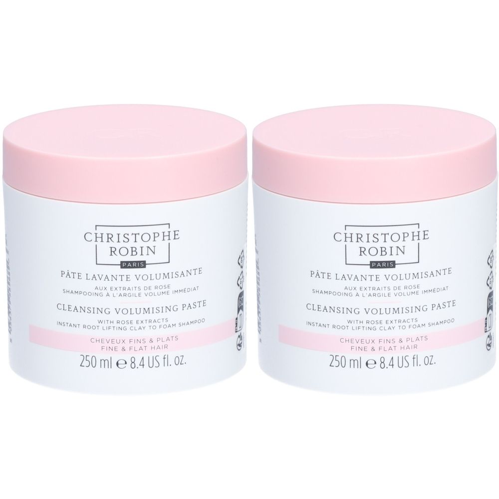 Twee witte potten met roze deksels. Opschrift: CHRISTOPHE ROBIN, PÂTE LAVANTE VOLUMISANTE, CLEANSING VOLUMISING PASTE.