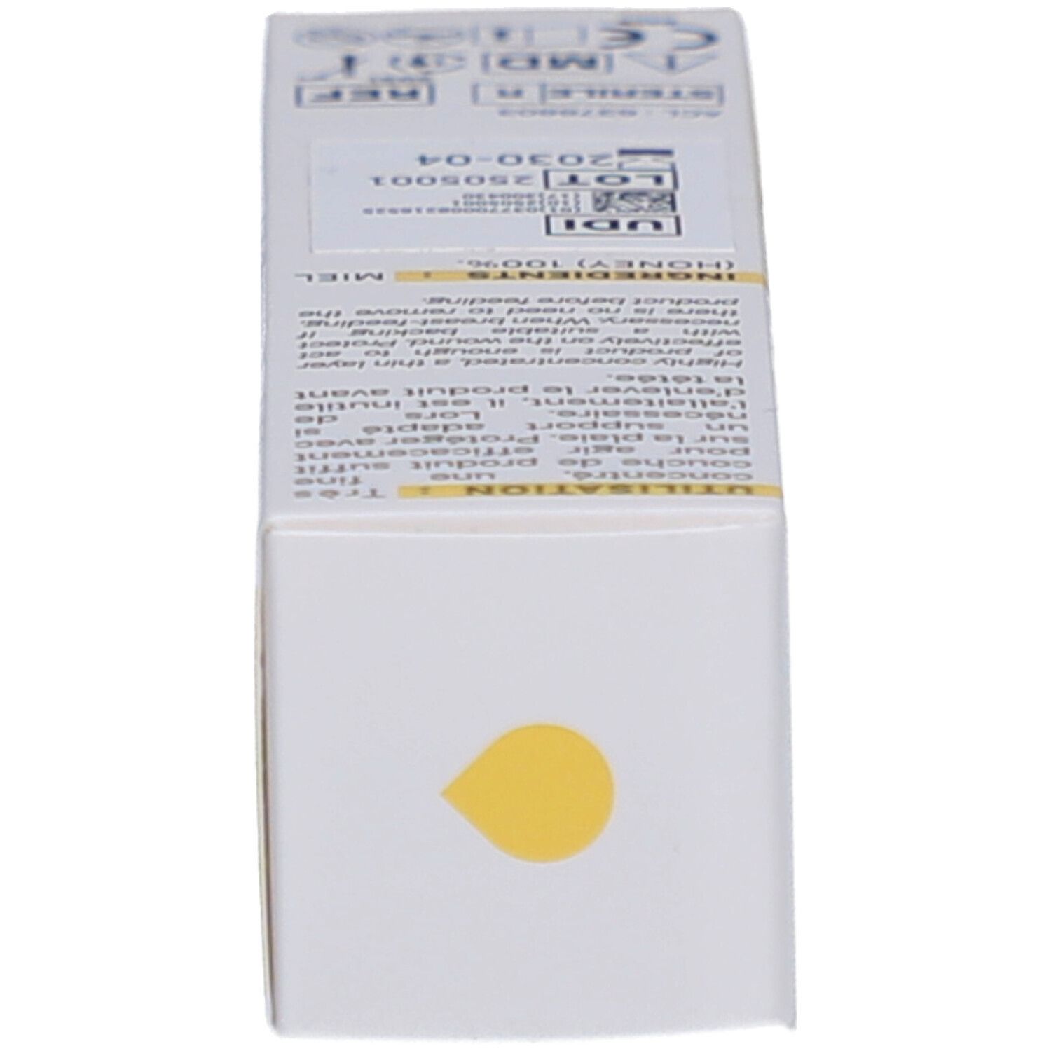 Dessous de la boîte. Goutte jaune. Texte: ingrédients, numéro de lot, date de péremption.