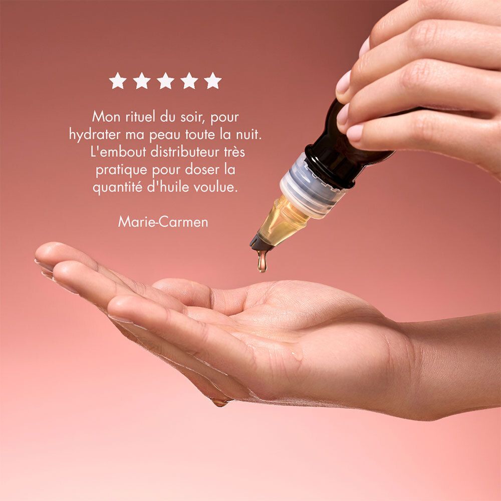 Hand met olie besprenkeld. Applicator van de fles. Tekst: Marie-Carmen, 5 sterren beoordeling.