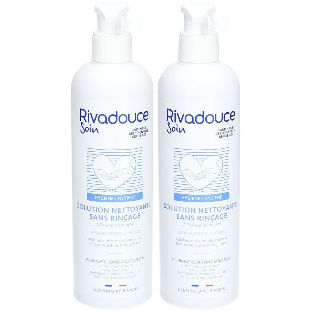 Twee witte flessen met pomp. Opschrift: Rivadouce, Solution Nettoyante Sans Rinçage. Hygiëneproduct voor gezicht en lichaam.