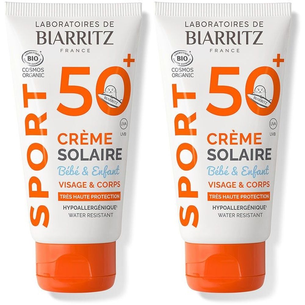 Twee tubes zonnecrème voor baby's en kinderen. Wit met oranje accenten. Tekst: SPF 50, Crème Solaire, Visage & Corps.