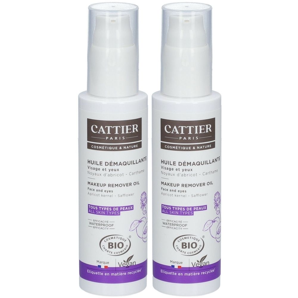 Twee witte flessen met pomp. Opschrift: Cattier Paris, Huile Démaquillant, Makeup Remover Oil. Bio-certificering en Vegan-logo.