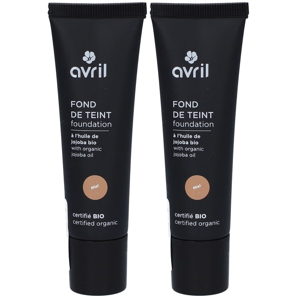 Twee zwarte tubes foundation. Opschrift: Avril, FOND DE TEINT, foundation, met biologische jojoba-olie. Tint Miel. Gecertificeerd BIO.