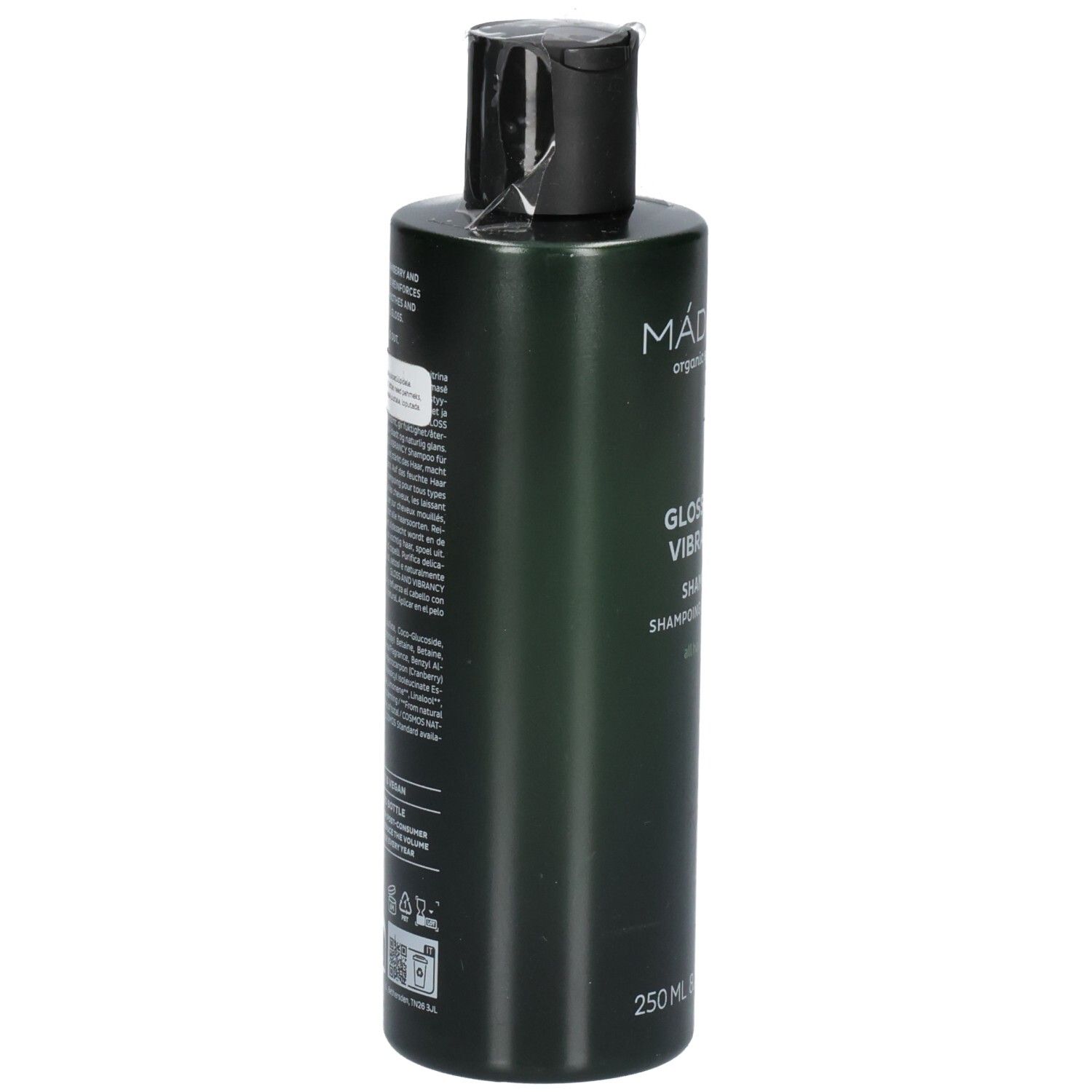 Achterkant van een groene shampoofles. Etiket bevat ingrediënten en gebruiksinstructies.