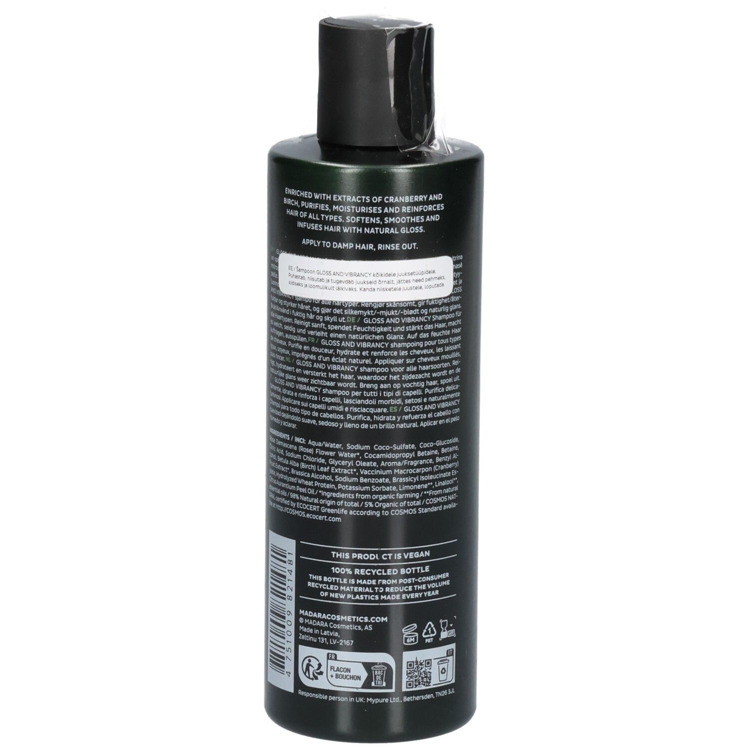 Achterkant van een groene shampoofles. Etiket bevat ingrediënten, instructies en zegels.