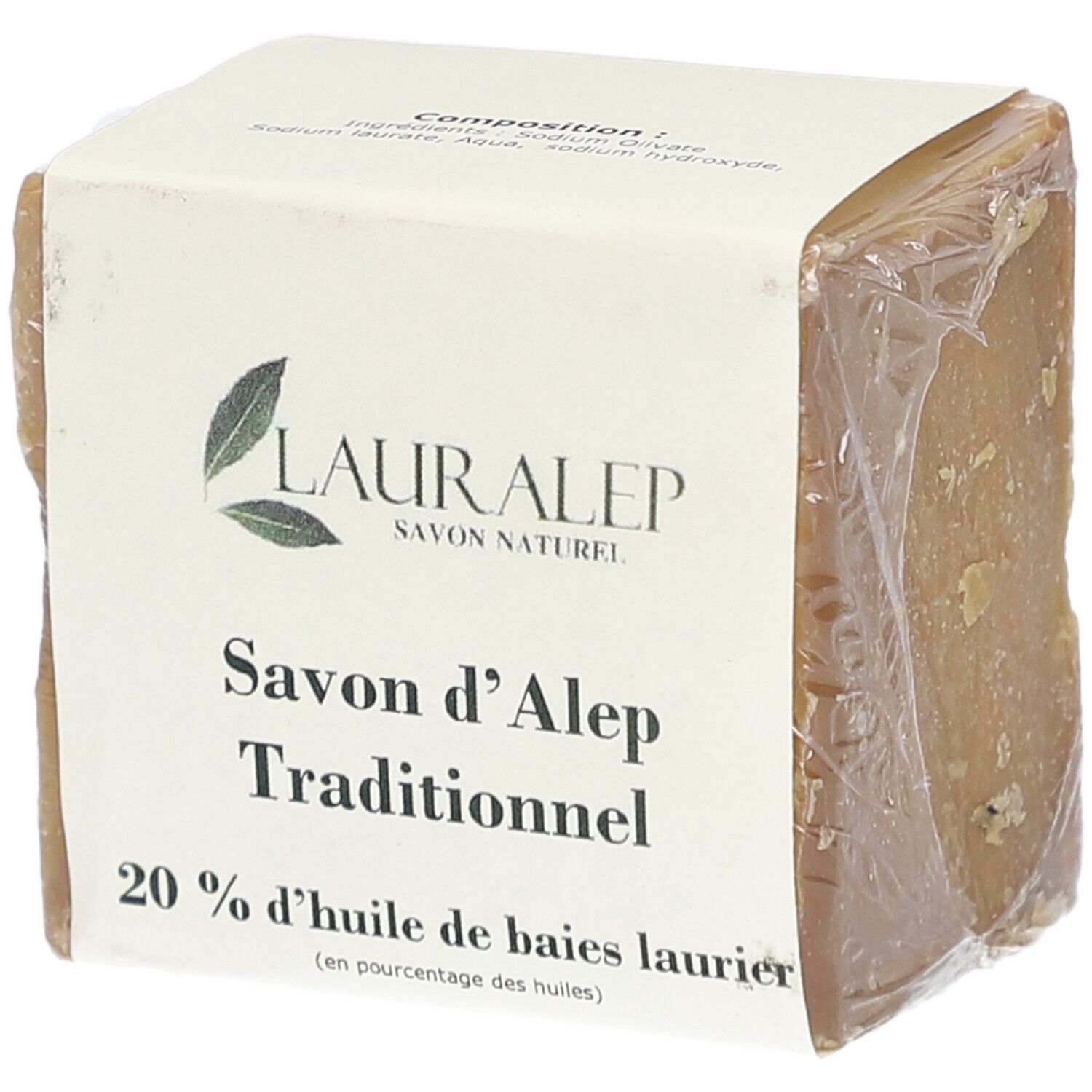 Vierkant blok zeep, verpakt in papier en plastic folie. Opschrift: LAURALEP, Savon d'Alep Traditionnel, 20% huile de baies laurier.