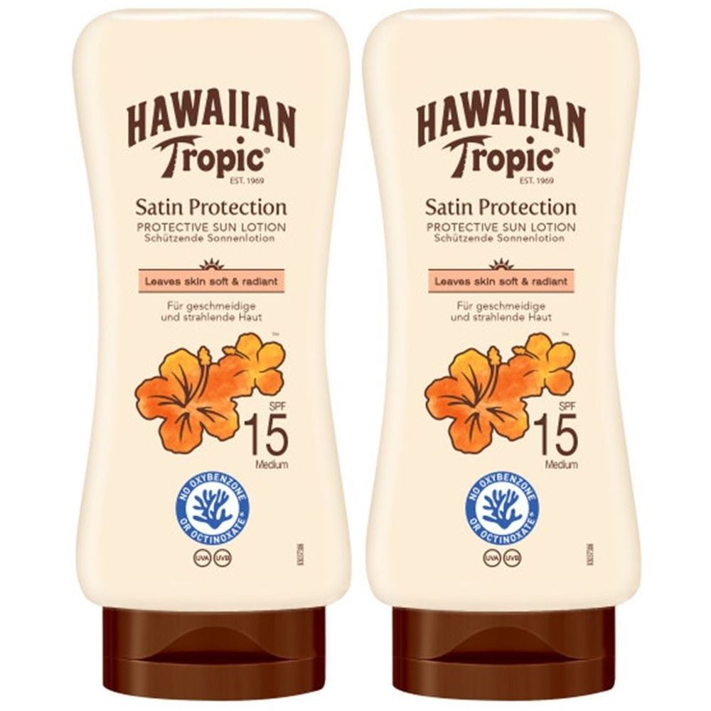 Deux flacons de lotion solaire. Inscription: HAWAIIAN Tropic, Satin Protection, SPF 15. Avec motif floral et logo.
