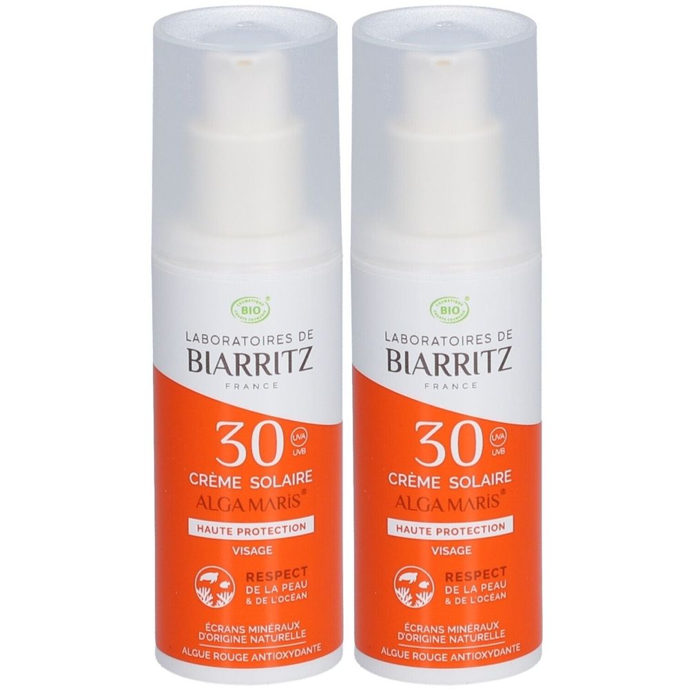 Twee witte flacons met oranje etiketten. Op de etiketten staat "Laboratoires de Biarritz" en "Crème Solaire Alga Maris SPF30". Gezicht zonnebrandcrème.