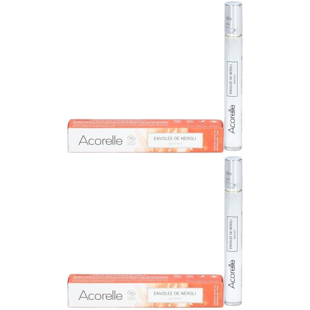 Deux flacons et boîtes. Sur les flacons, "Acorelle Envolée de Néroli". Les boîtes sont orange et blanches avec des inscriptions.