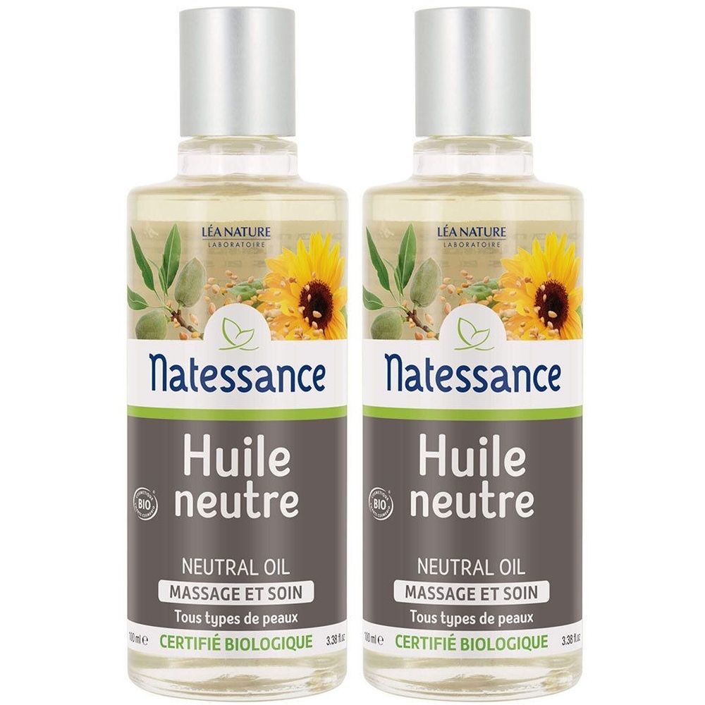 Twee flessen Natessance Neutrale Biologische Olie, zilveren doppen. Heldere vloeistof, etiket met zonnebloemen en amandelen.