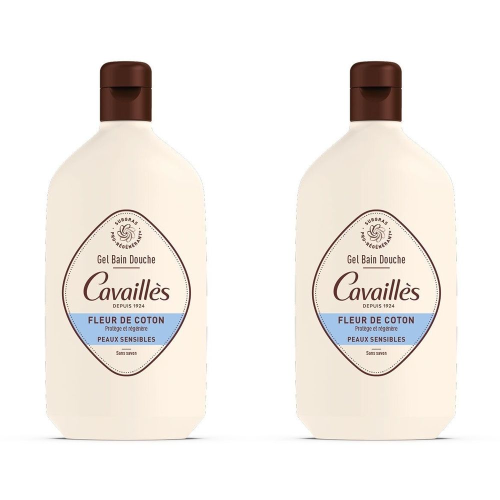 Twee flessen douchegel. Witte fles met bruine dop. Opschrift: Cavaillès, Fleur de Coton, gevoelige huid.