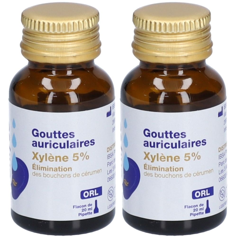 Twee bruine glazen flesjes met gouden doppen. Labels met "Gouttes auriculaires Xylène 5%" en "ORL". Bevat een pipet.