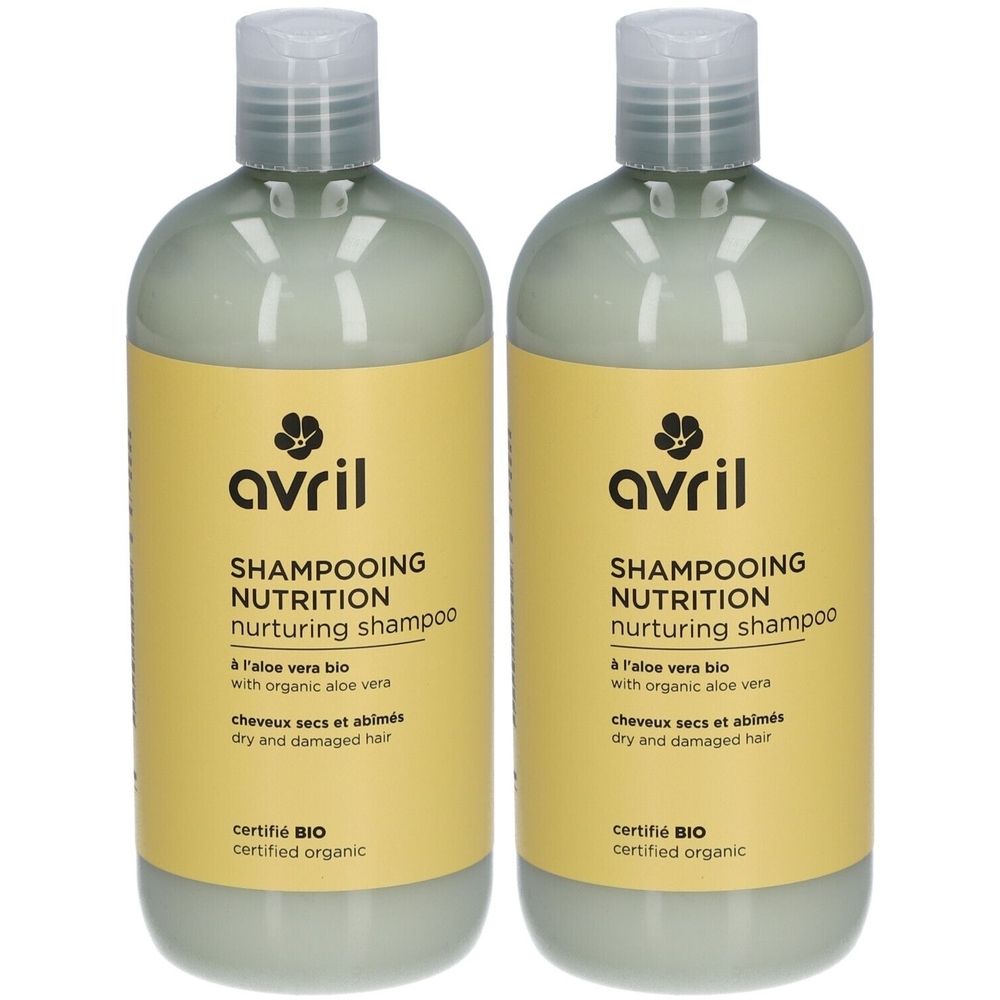 Twee shampoo flessen. Gele etiketten met zwarte tekst: "avril SHAMPOOING NUTRITION nurturing shampoo". Gecertificeerd BIO.