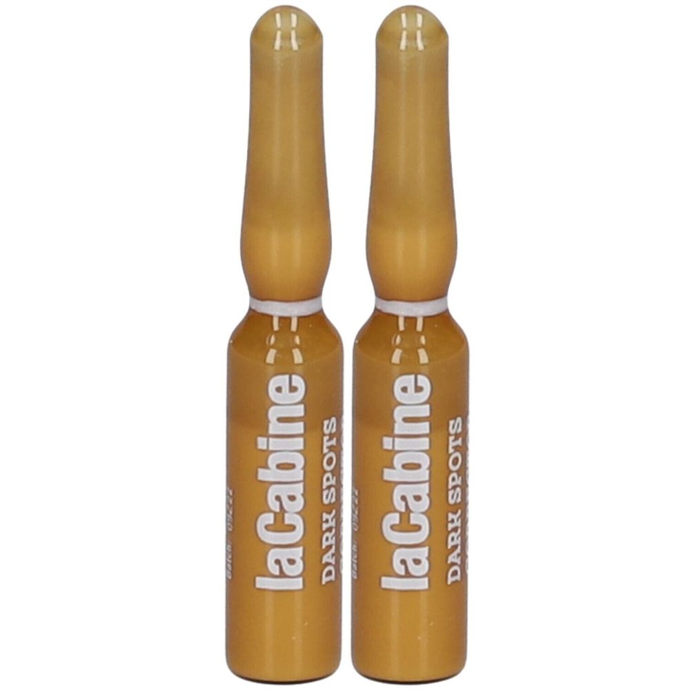 Deux ampoules de liquide doré. Inscription: laCabine DARK SPOTS.