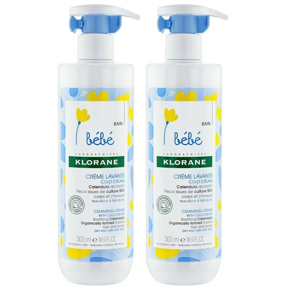 Deux flacons de Klorane Bébé Crème lavante Cold Cream. Flacons blancs avec motifs bleus et jaunes. Pompes bleues.