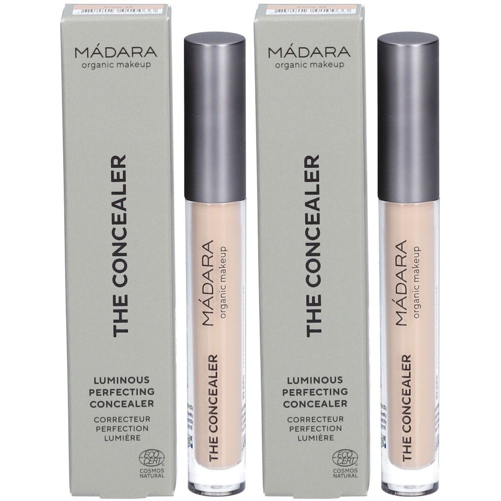 Twee concealers en verpakkingen. Op de verpakkingen staat "Mádara THE CONCEALER". De concealers zijn lichtbeige.
