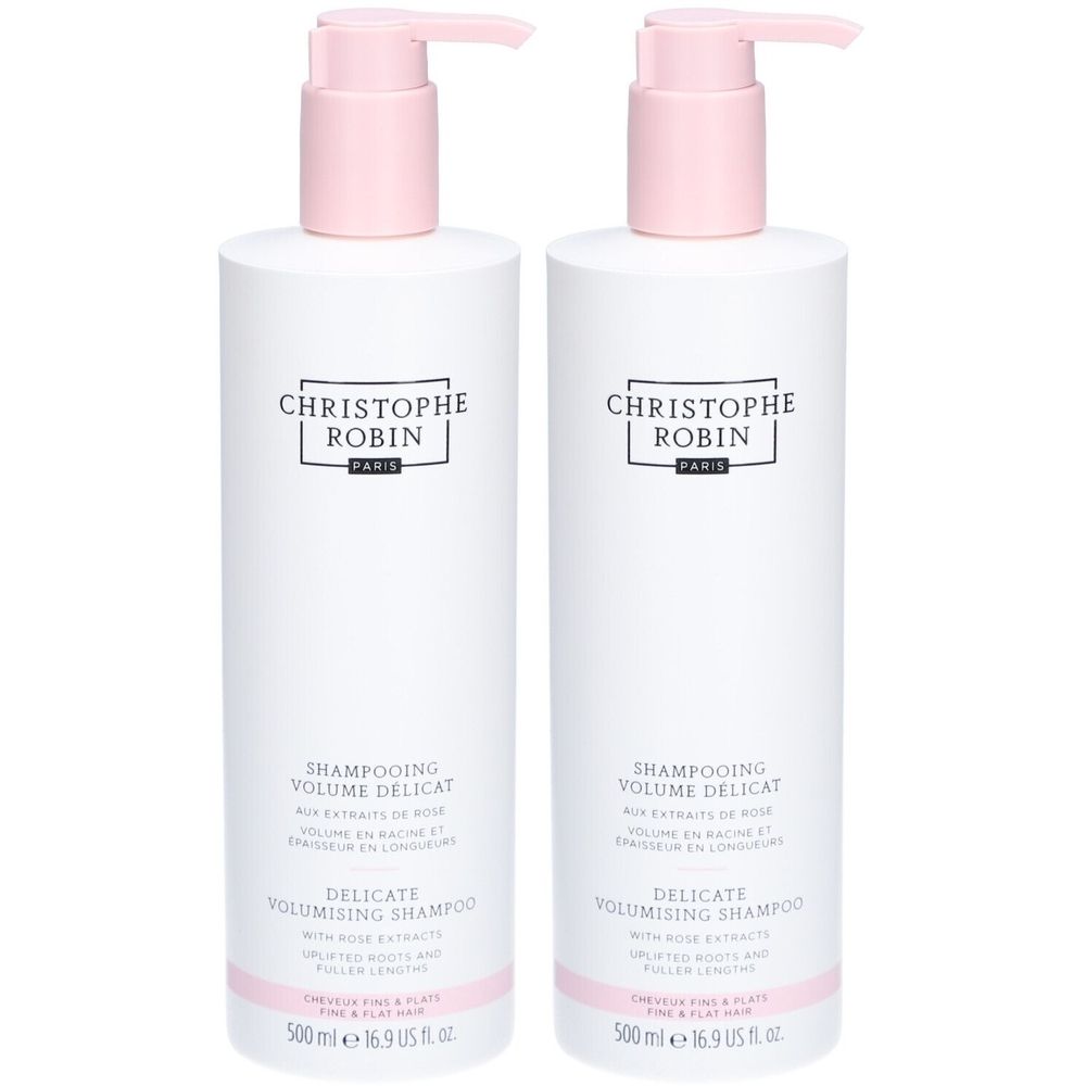 Twee witte shampoo flessen met roze pomp. Opschrift: CHRISTOPHE ROBIN. Tekst: DELICATE VOLUMISING SHAMPOO. Volume: 500 ml.