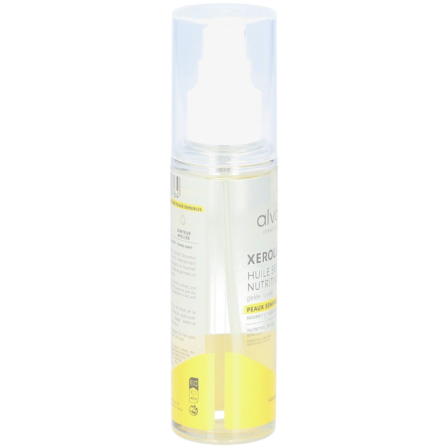 Transparante sprayfles met geel etiket. Tekst: alvadiem, Xérolia Huile Sèche Nutritive, Peaux sensibles et sèches. Details en logo's.