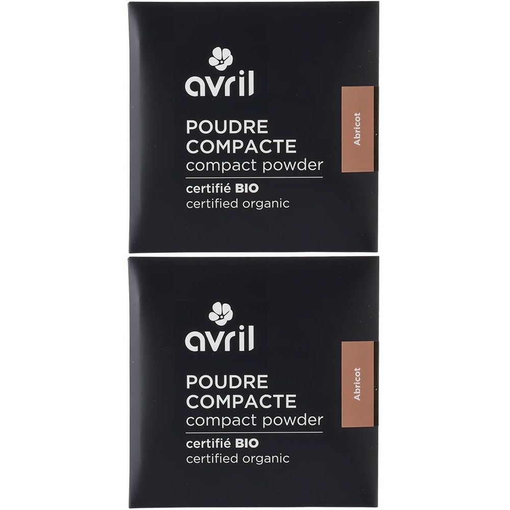 Twee zwarte verpakkingen van Avril compact poeder. Opschrift: certifié BIO. Kleur: abrikoos. Tekst in het Engels en Frans.