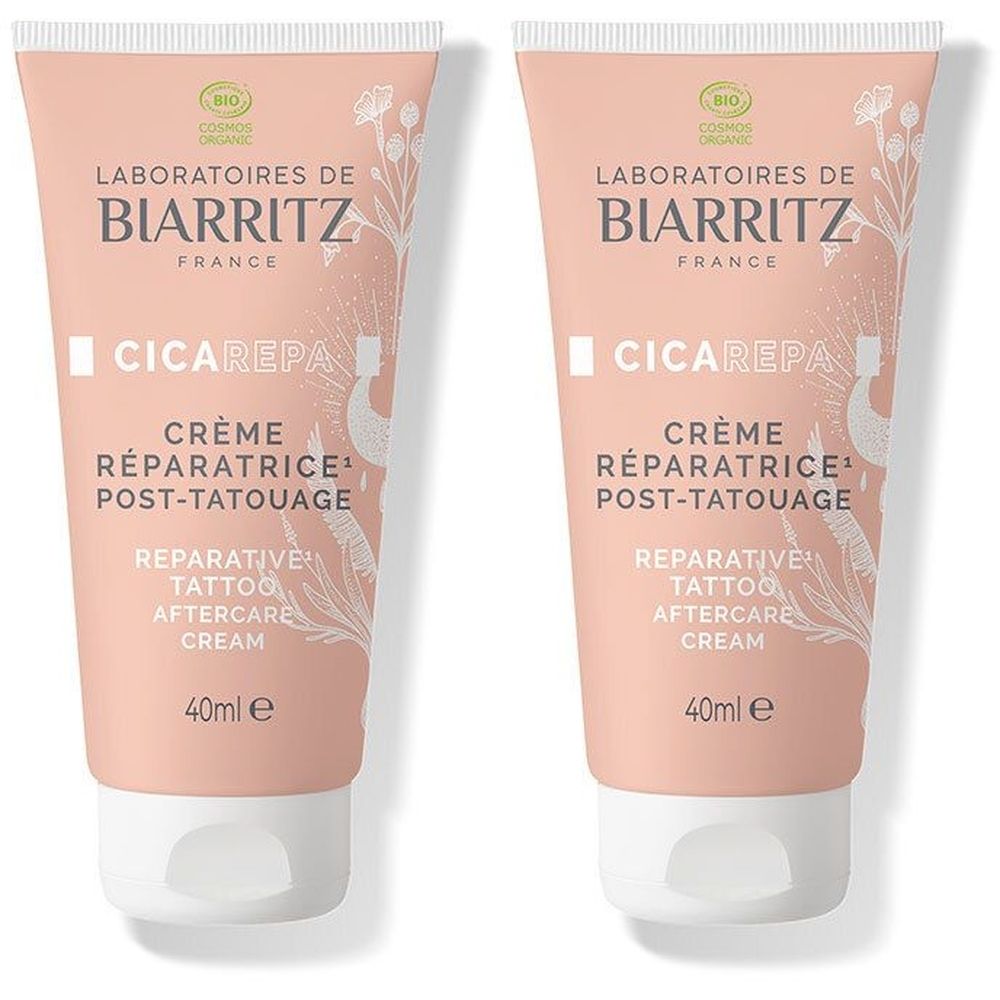 Deux tubes de CicaRepa Crème Réparatrice Post-Tatouage. Tubes roses avec bouchon blanc. Texte: Laboratoires de Biarritz, 40ml.