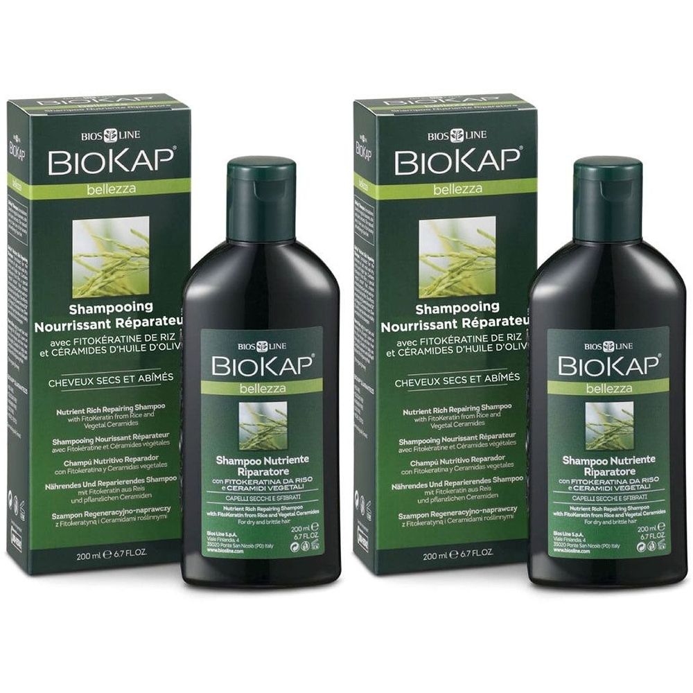Twee flessen en twee dozen BIOKAP shampoo. Zwarte flessen met groene dop. Groene dozen met productinformatie.