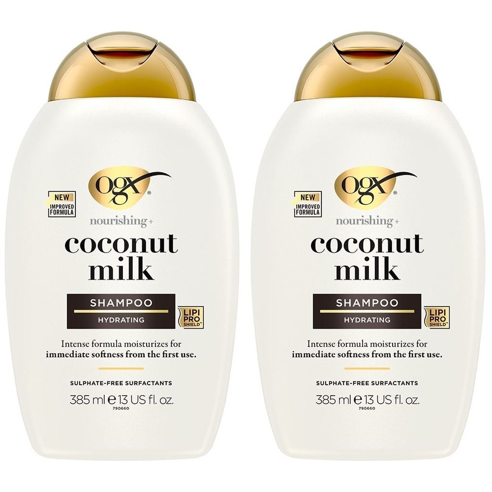Twee witte shampoo flessen met gouden doppen. Opschrift: OGX Coconut Milk Shampoo. Hydraterend.