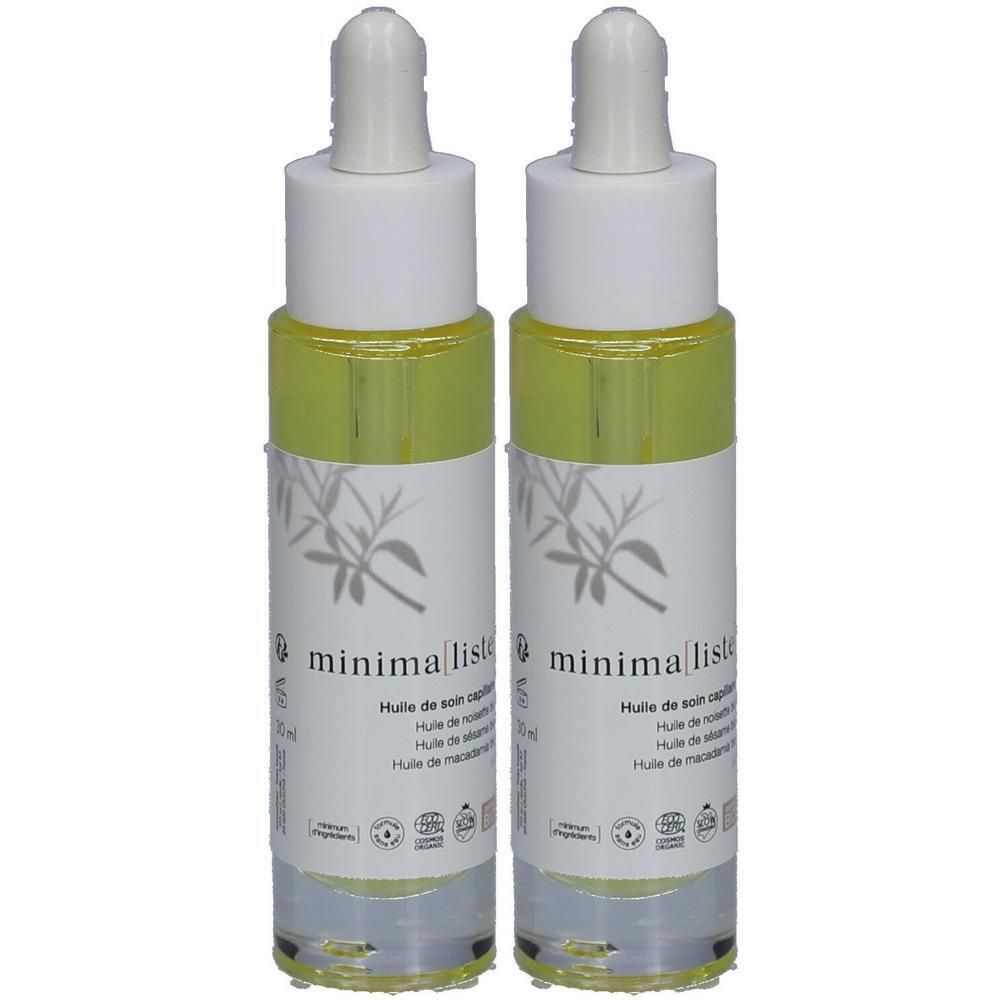 Deux flacons d'huile capillaire bio. Bouchons blancs avec pipettes. Étiquettes avec logo et texte. Flacons transparents avec liquide jaune.