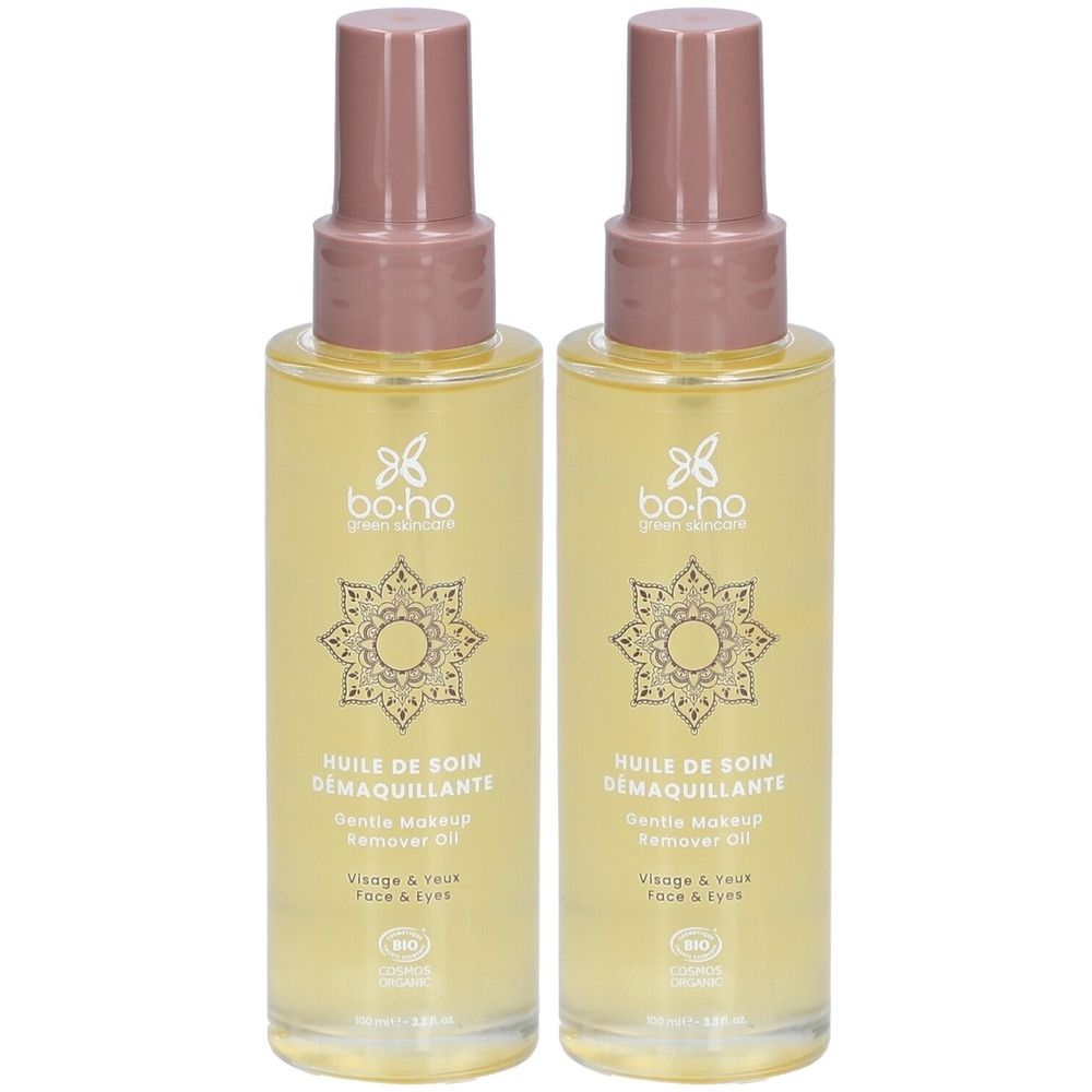 Deux flacons d'huile de soin démaquillante BOHO avec pompe. Huile jaune dans des flacons transparents avec bouchon rose.