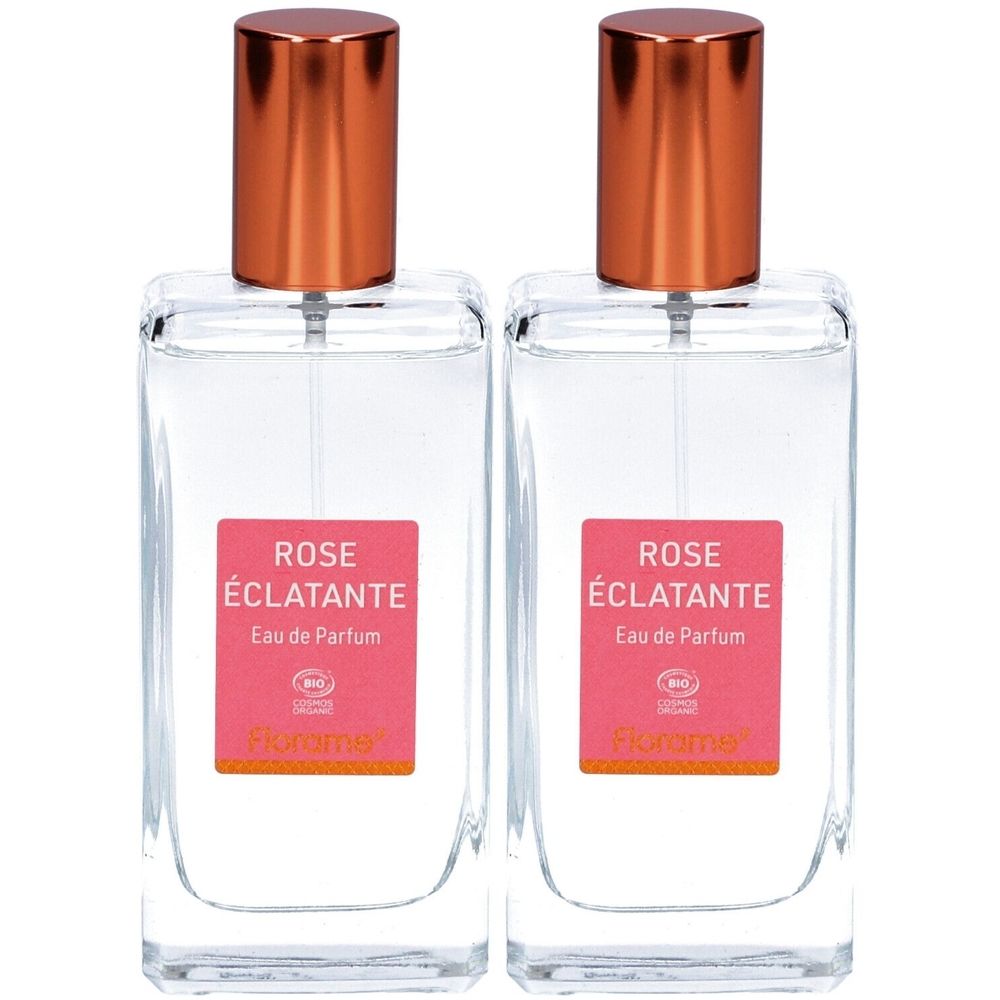 Deux flacons rectangulaires en verre avec bouchons cuivrés. Étiquette rose avec texte: ROSE ÉCLATANTE, Eau de Parfum. Certification bio.