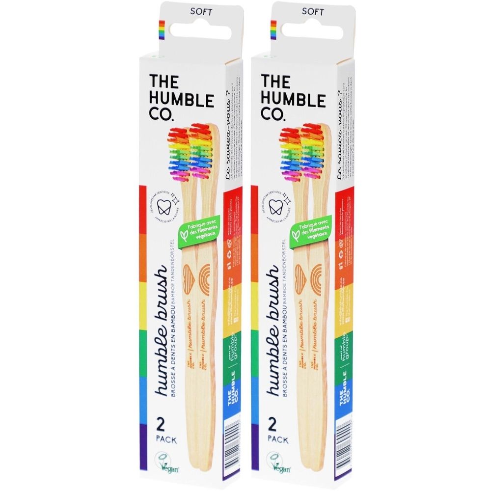 Twee verpakkingen tandenborstels. Opschrift: THE HUMBLE CO. Regenboogkleurige borstelharen. Vegan. 2-pack.